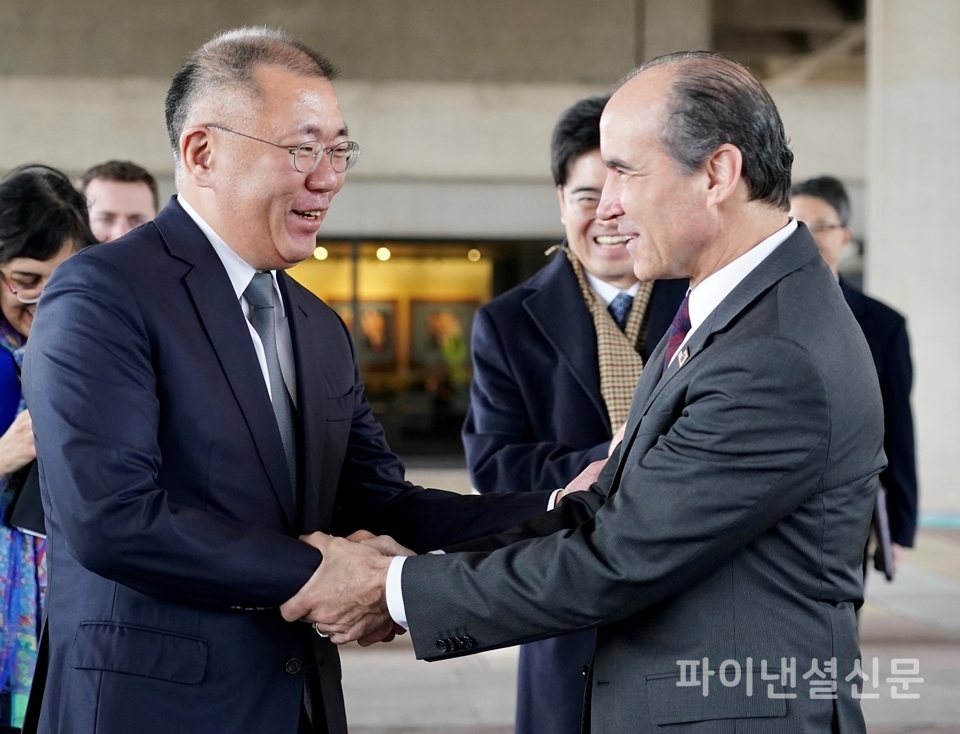 정의선 현대차그룹 수석부회장(사진 왼쪽)과 미국 에너지부 마크 메네제스 차관이 미국 에너지부 청사 앞에서 악수를 나누고 있다. (사진=현대차)