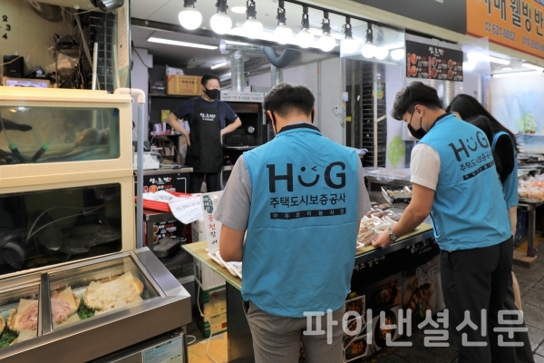 HUG직원들이 15일 자매결연 관계인 부산 남구 용호골목시장을 방문해 구입할 물품을 고르고 있다. (사진=HUG)